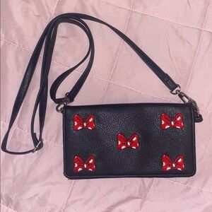 Sleek Black Crossbody Bag with Red Bow Details